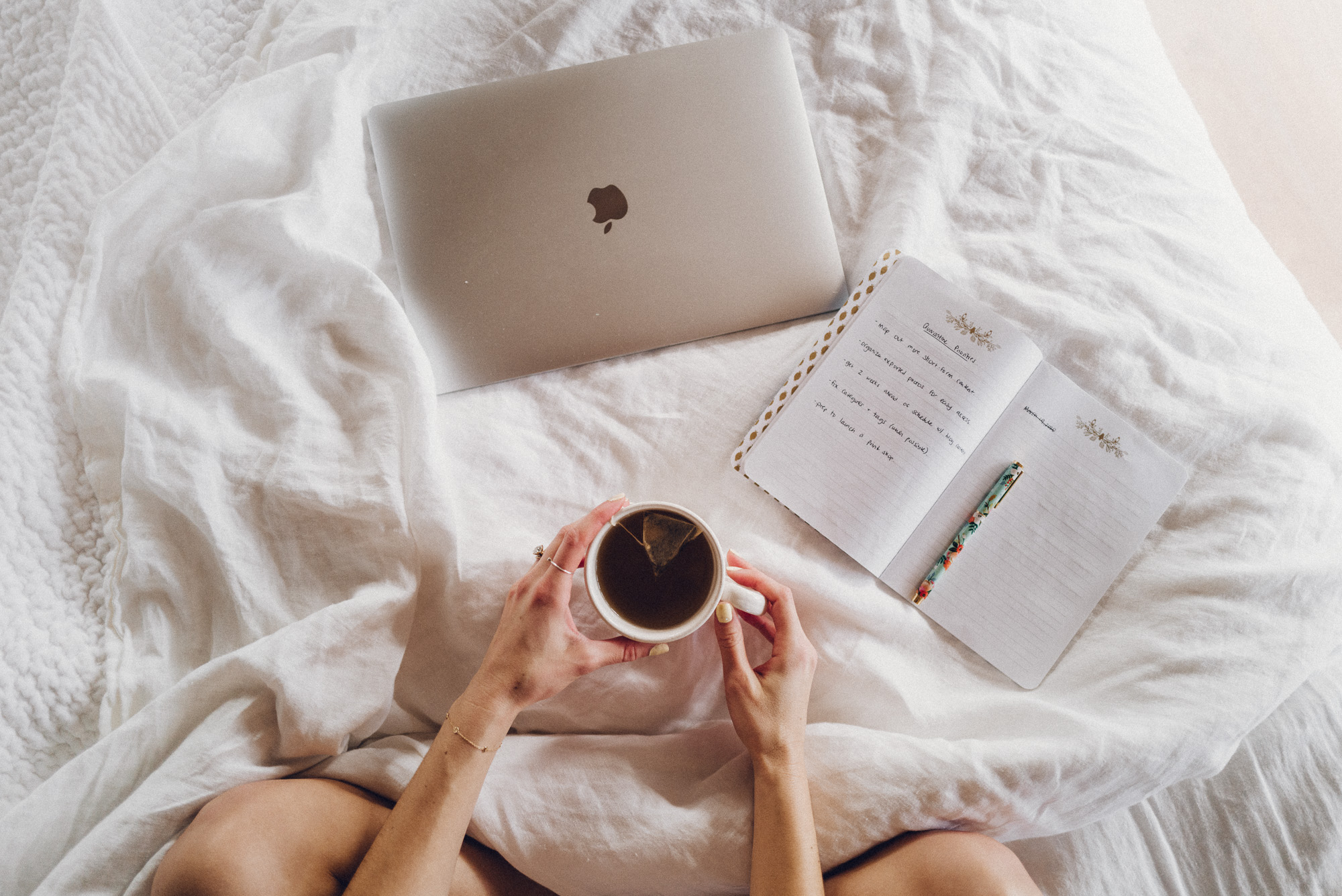 Small business tools including a laptop and notebook