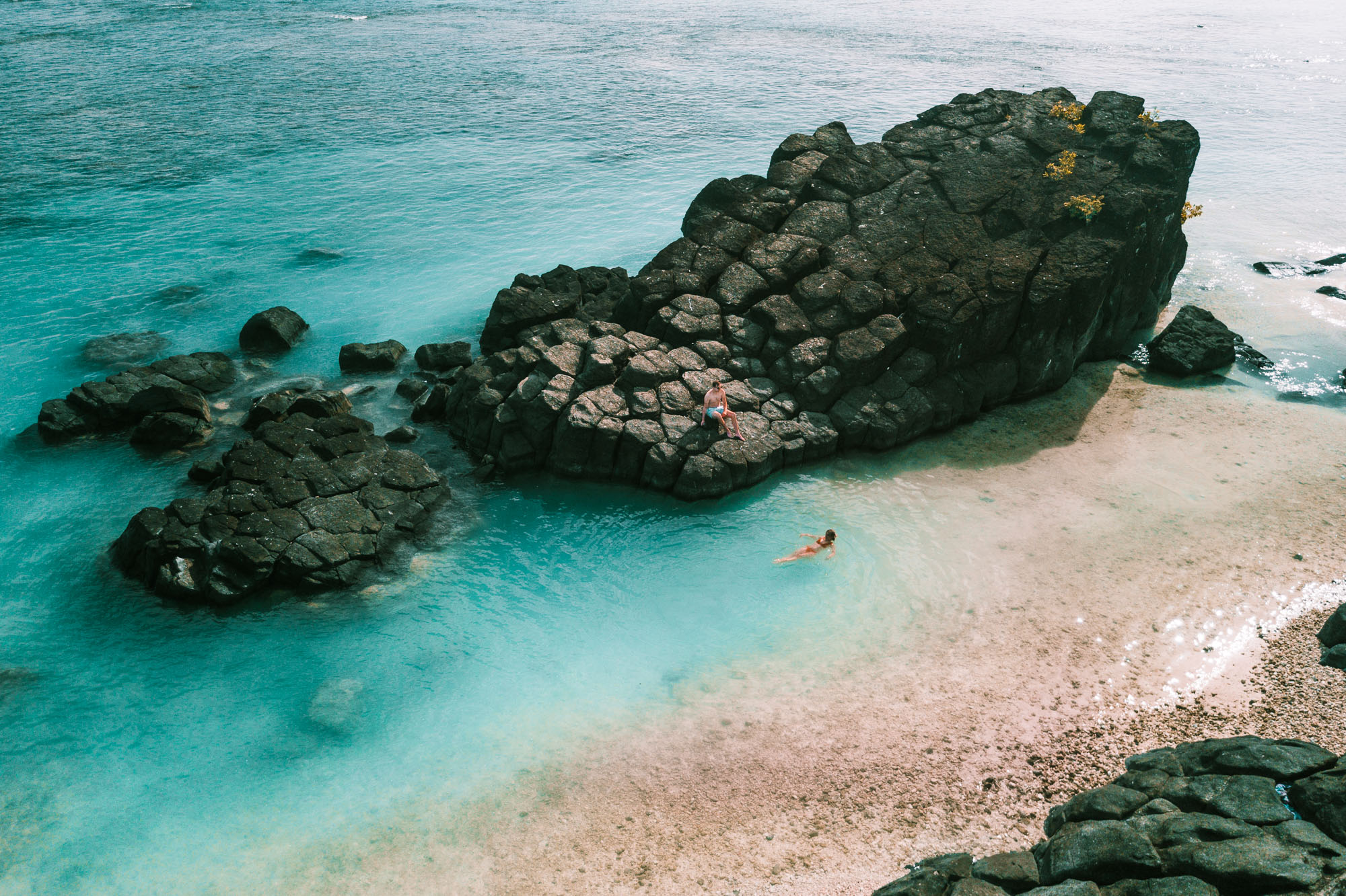Black rock for blue water swimming hole and sunset in Rarotonga, Cook Islands