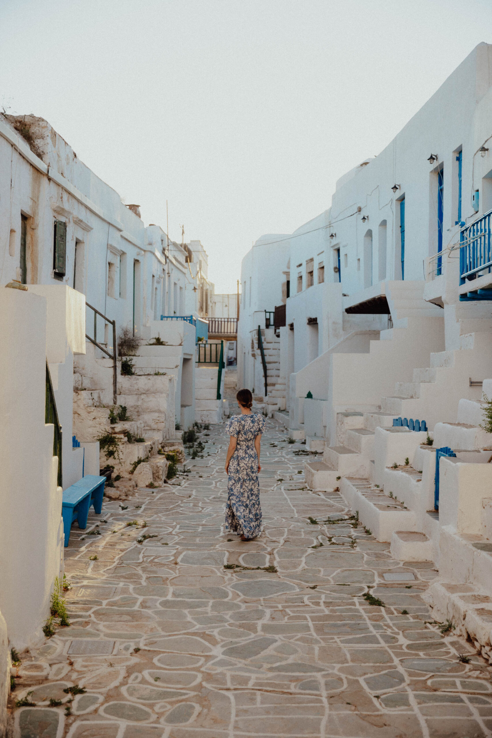 Charming downtown Chora Folegandros at night with illuminated white and blue buildings creating magical Greek island ambiance