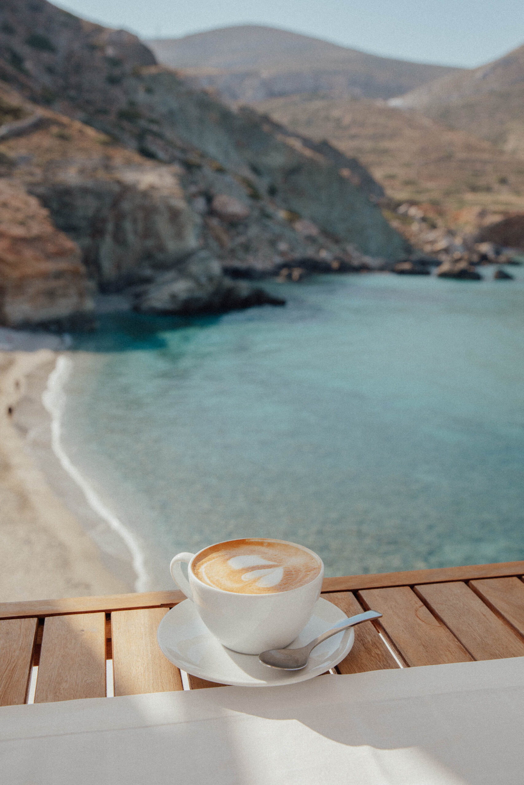 Morning coffee on private balcony at Blue Sand Hotel Folegandros with panoramic Aegean Sea views and traditional Cycladic architecture