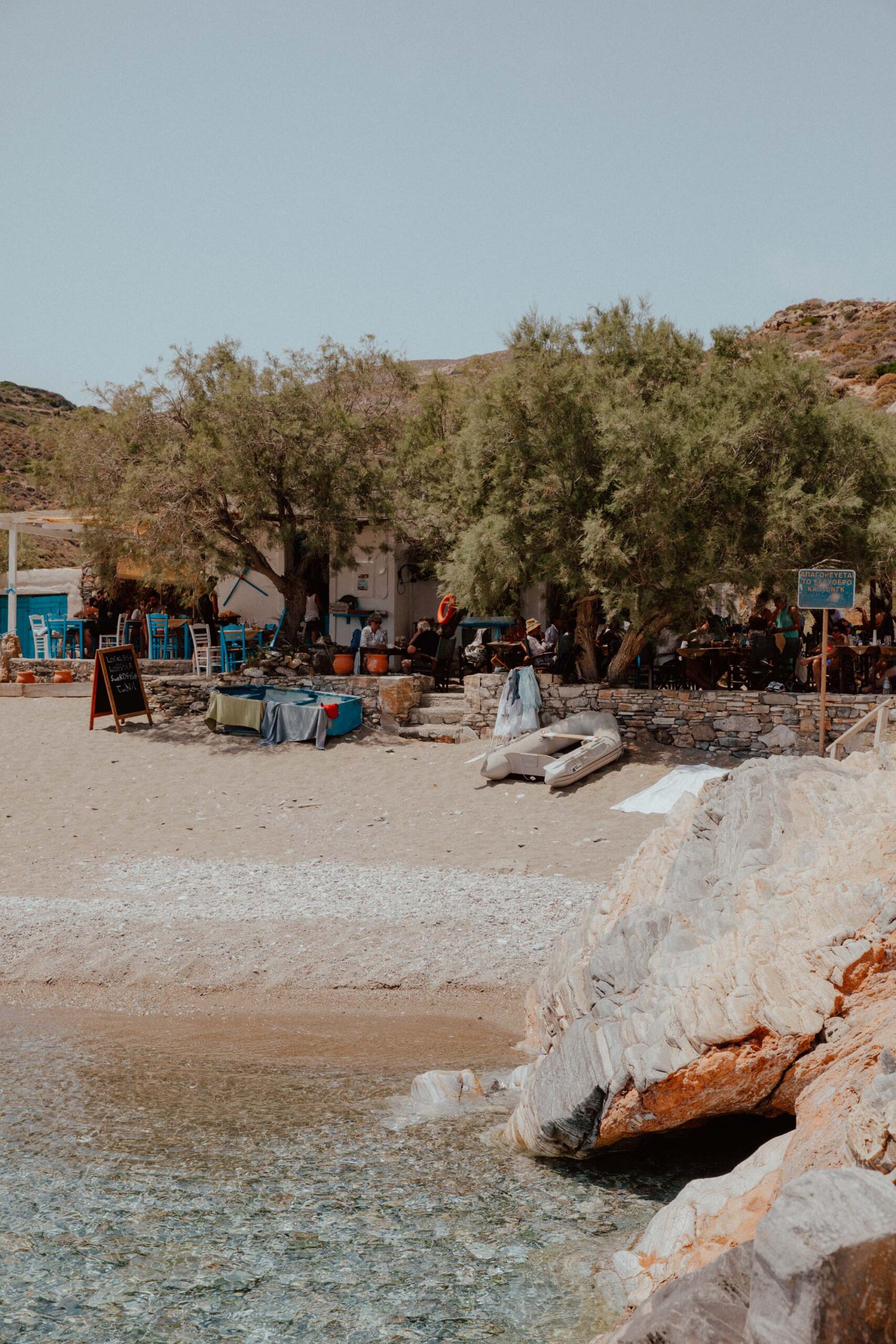 Restaurant on Agios Nikolaos Beach Folegandros with shallow turquoise waters and boat access