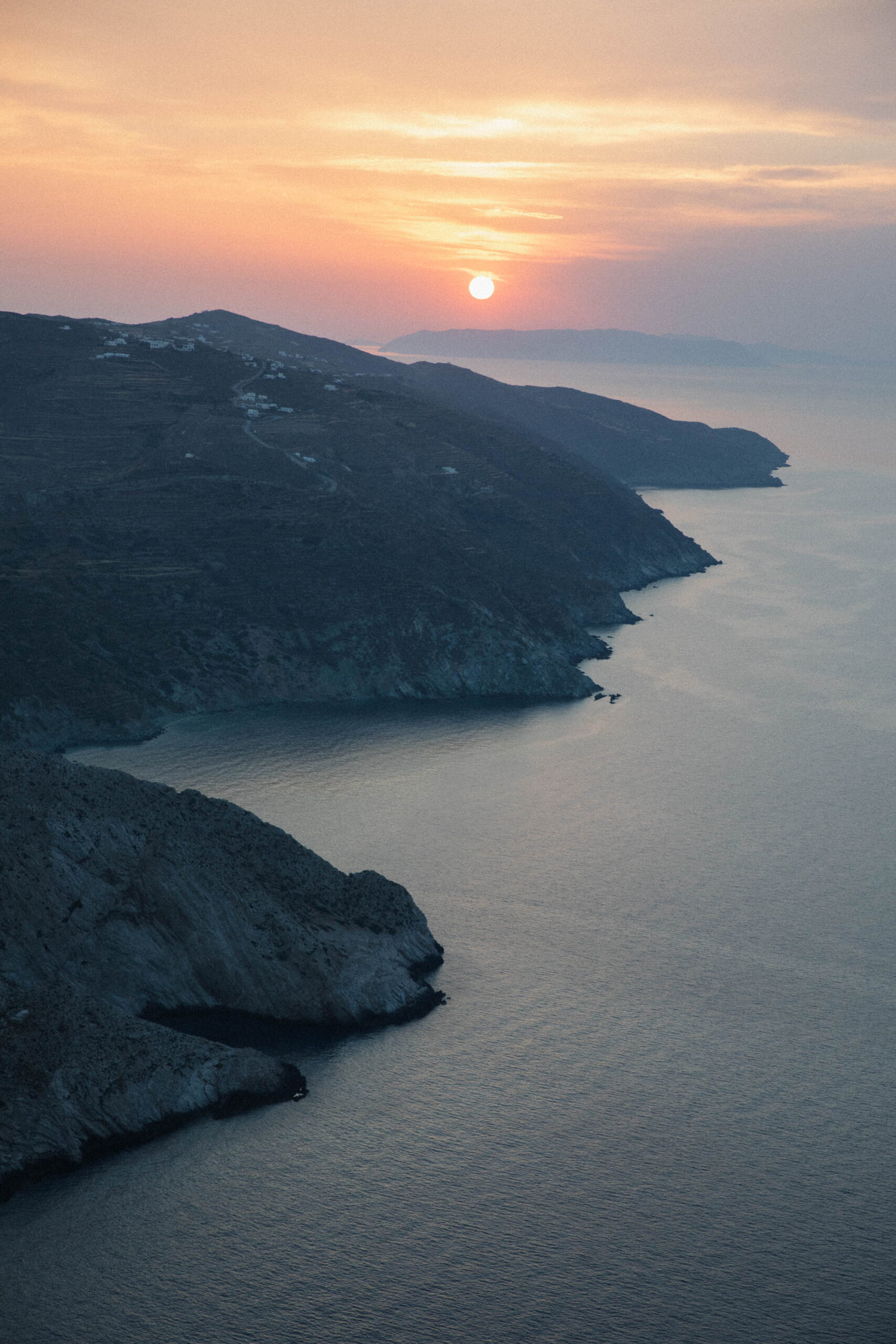 Breathtaking sunset view from Church of Panagia Folegandros with golden light over Aegean Sea panorama