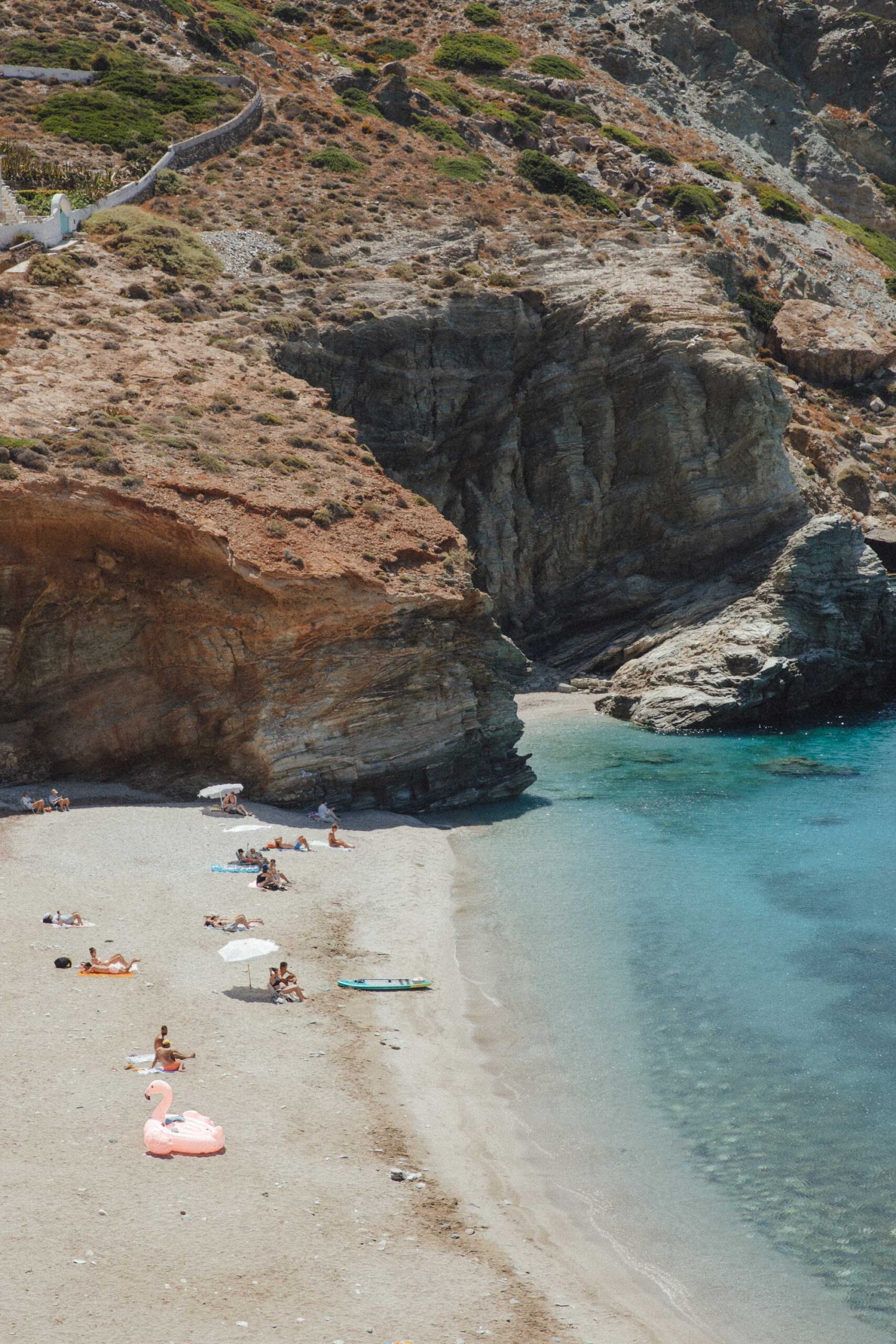 Agali Beach in Folegandros with crystal clear waters, pebbled shore and dramatic cliff surroundings