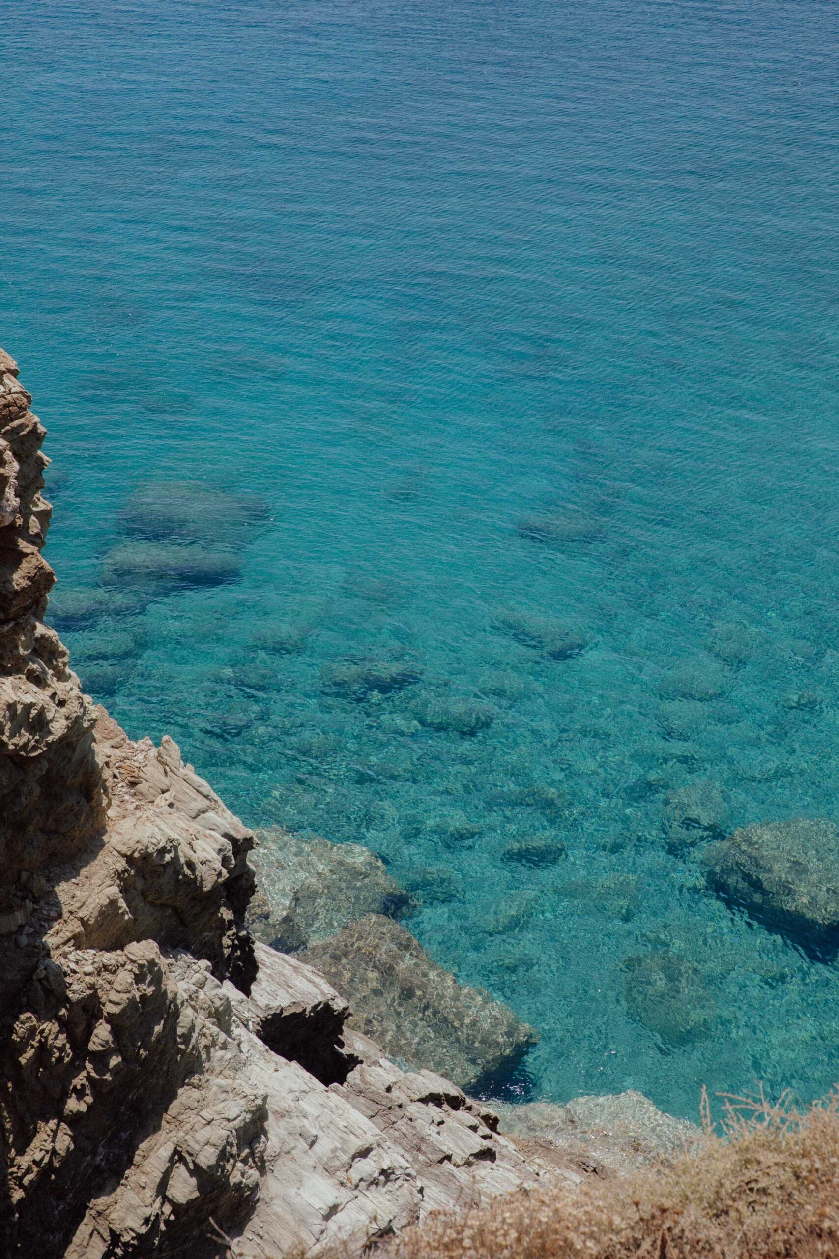 Turquoise water in folegandros with golden rocks