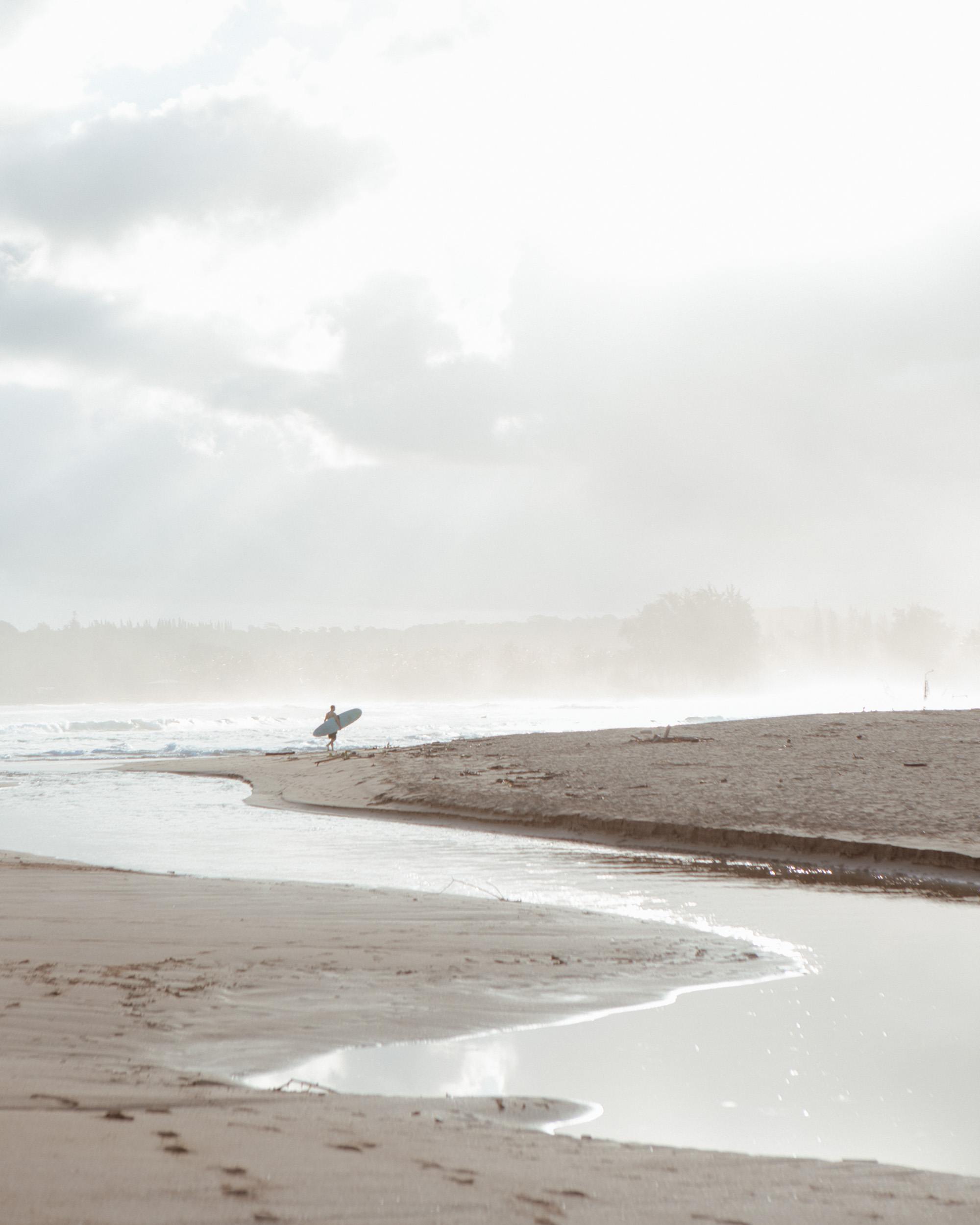A surfer on hanalei bay beach