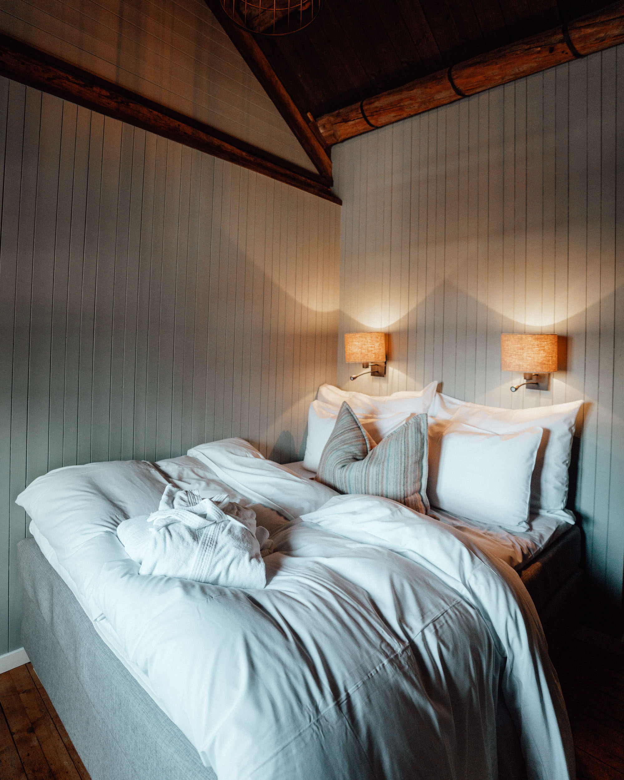 Bedroom of Hotel in Lofoten Norway Nusfjord Arctic Resort Traditional Fishermen Red Cabin with a Fjord View - Find Us Lost