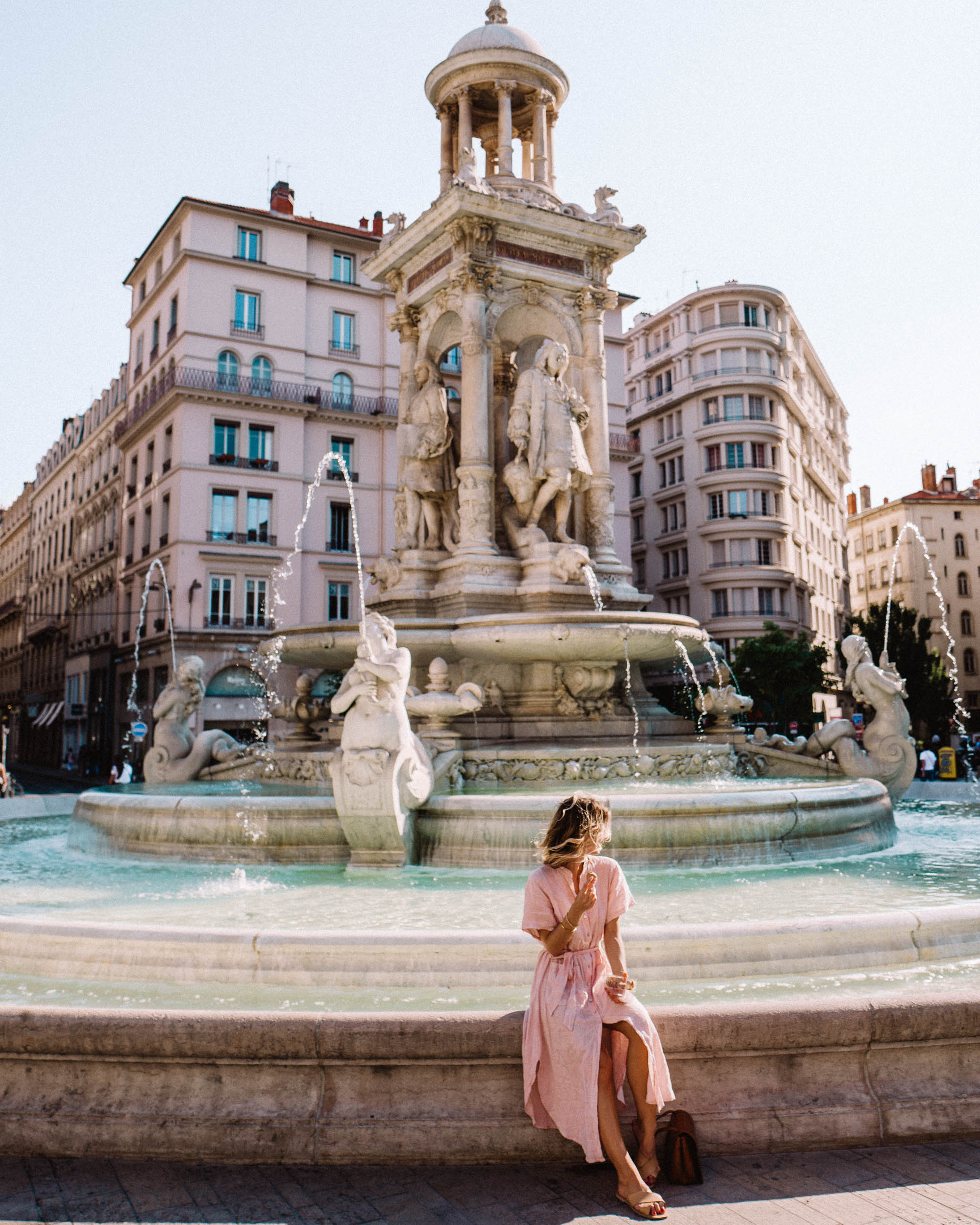 Pink and blue in Lyon France town square fountain
