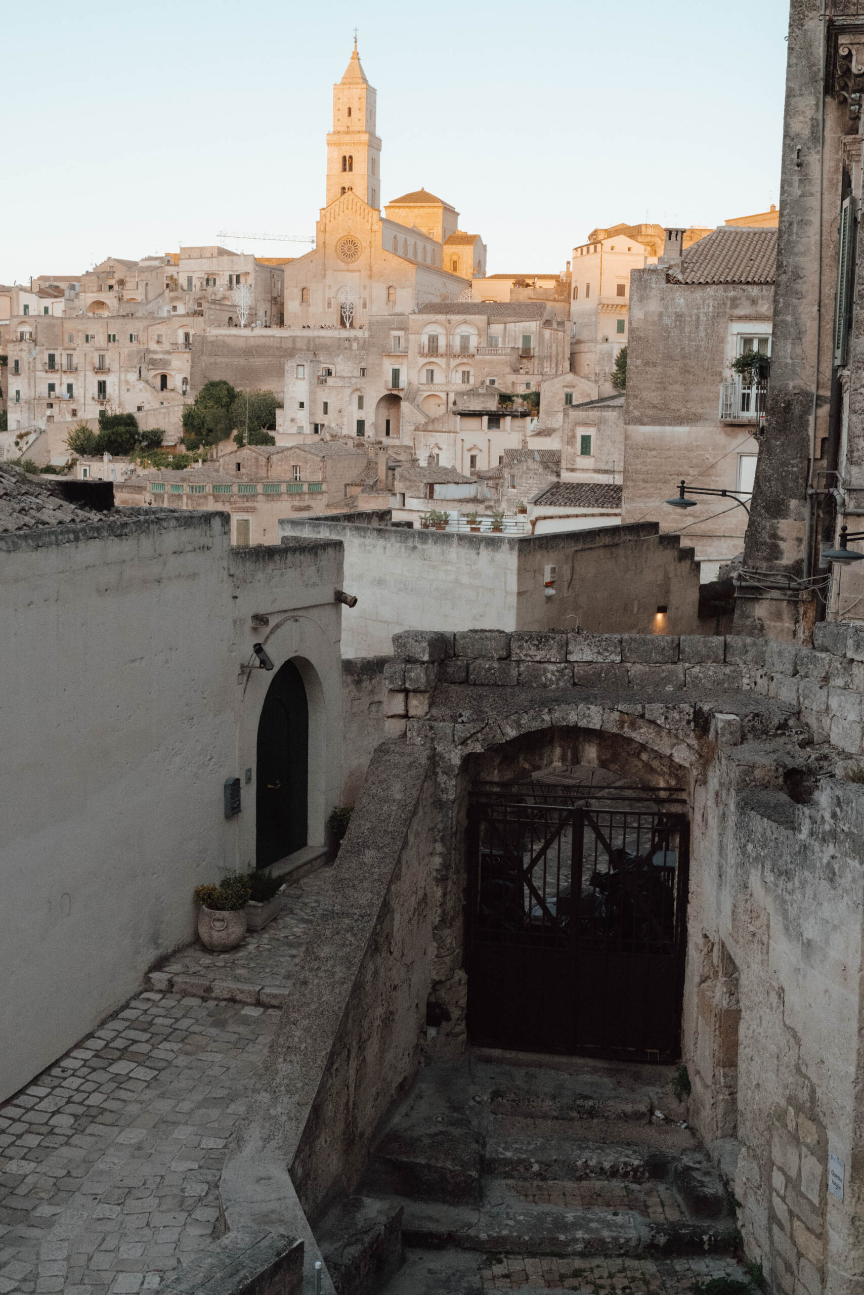 Golden sunset light illuminating 9000 year old cave houses in Matera UNESCO site Italy