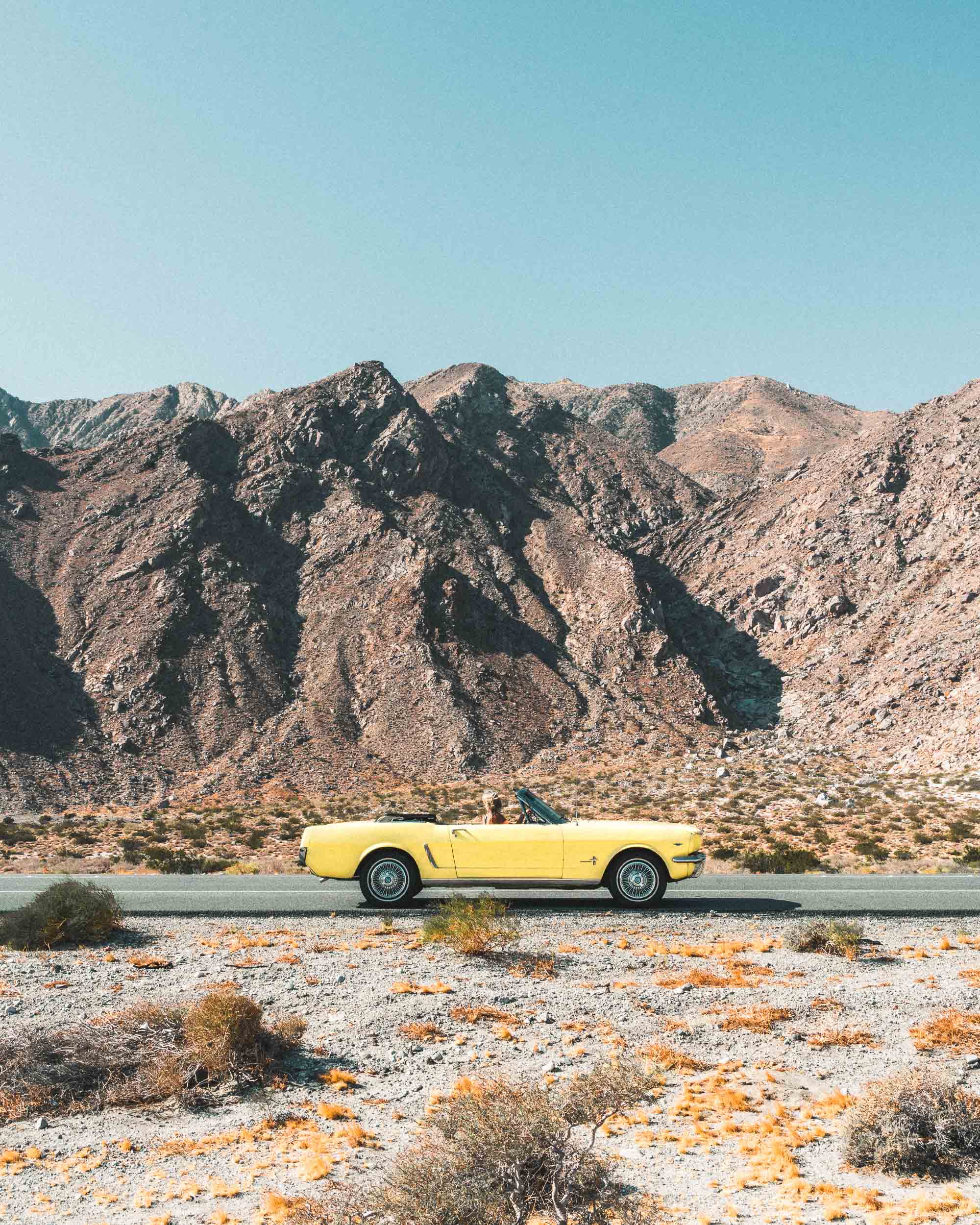 Vintage yellow car in the desert of Palm Springs California Find Us Lost