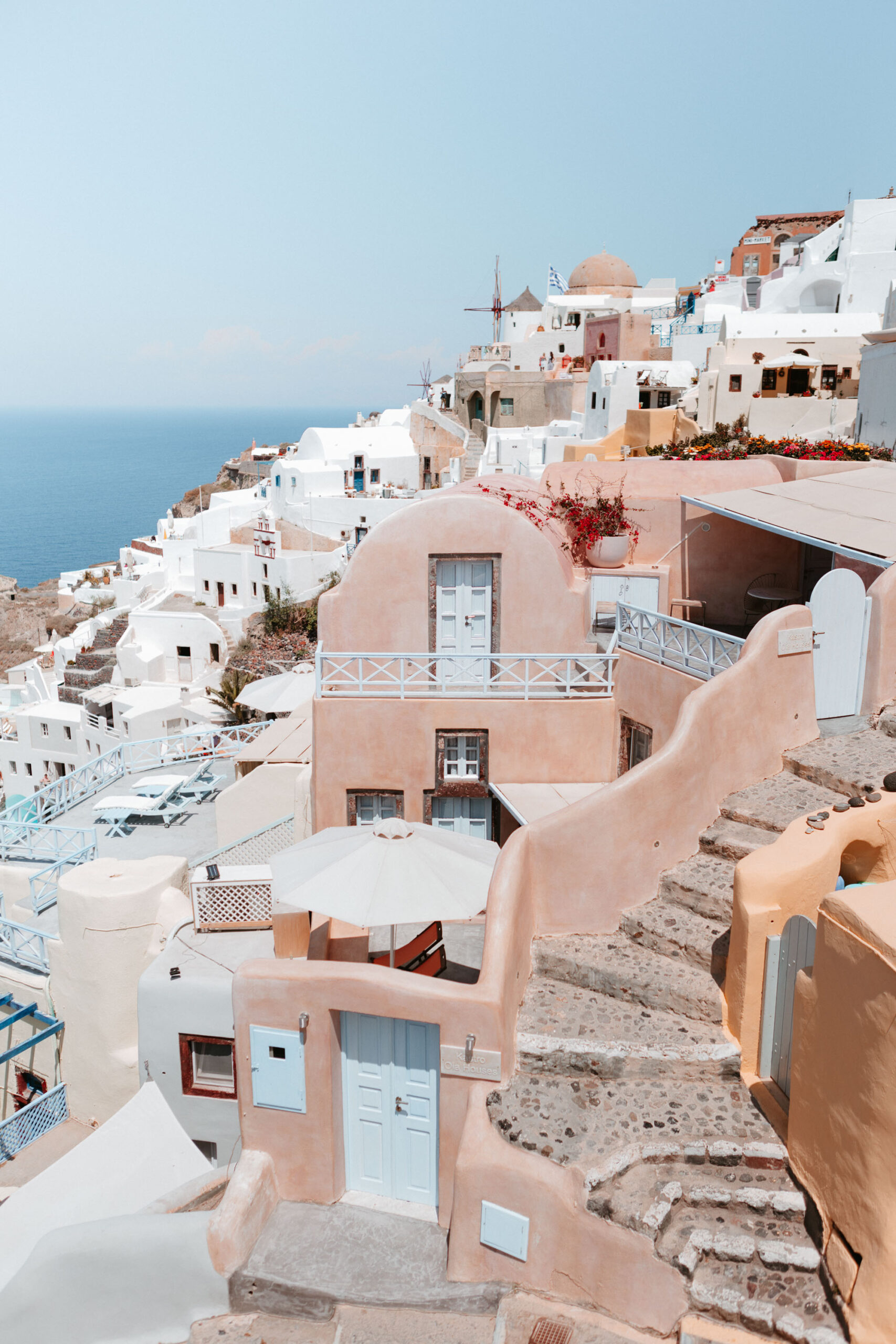 Traditional Greek taverna in Santorini with rustic wooden decor and hanging dried herbs
