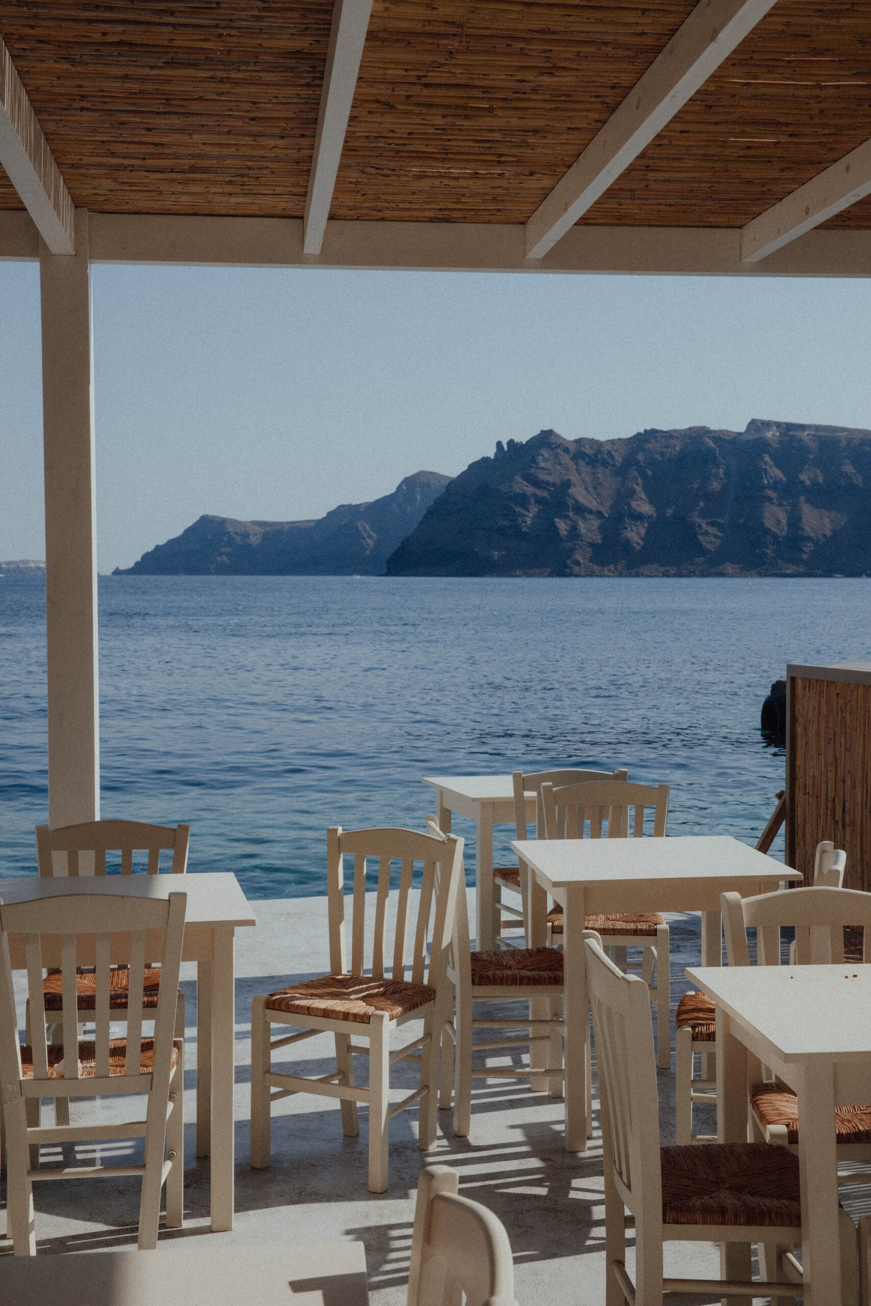 Restaurant with an open terrace offering stunning views of the Aegean Sea in Santorini, Greece.