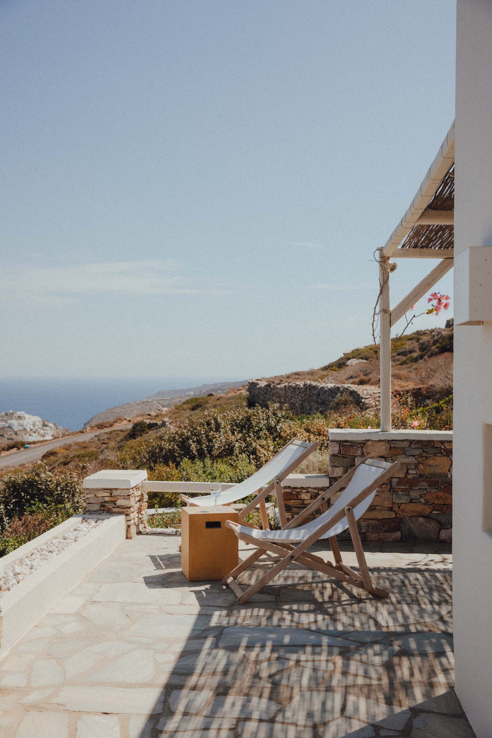 Chairs on a balcony overlooking the Aegean at a suite in Verina Astra