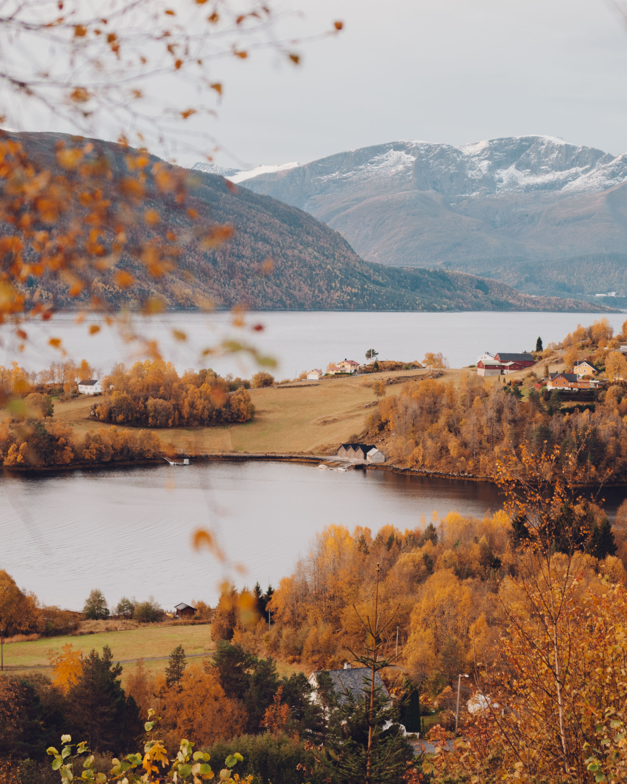 Views from Storfjord Hotel in Skodje, Norway with large windows framing spectacular fjord views and mountains beyond