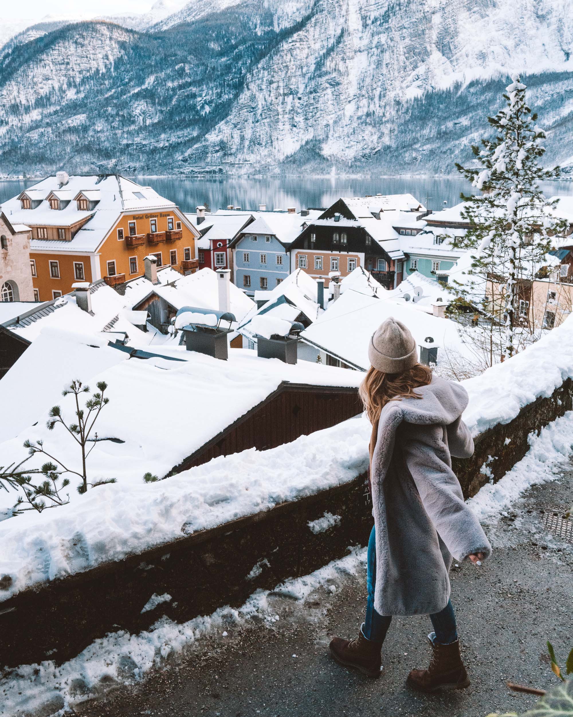 View of hallstatt austria snow covered rooftops from path up the mountain
