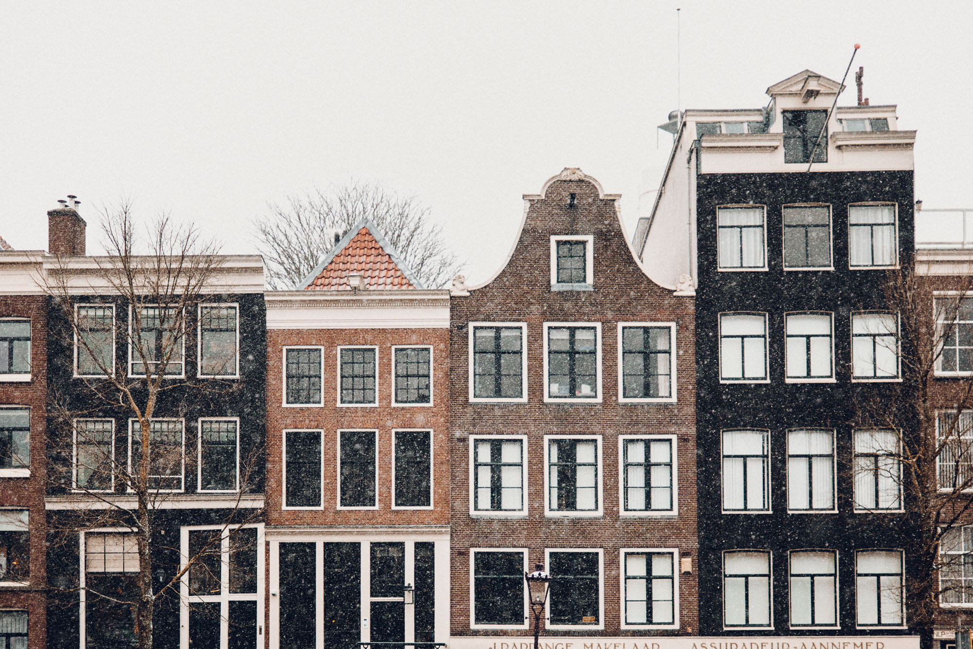 Amsterdam canal houses in the snow Find Us Lost