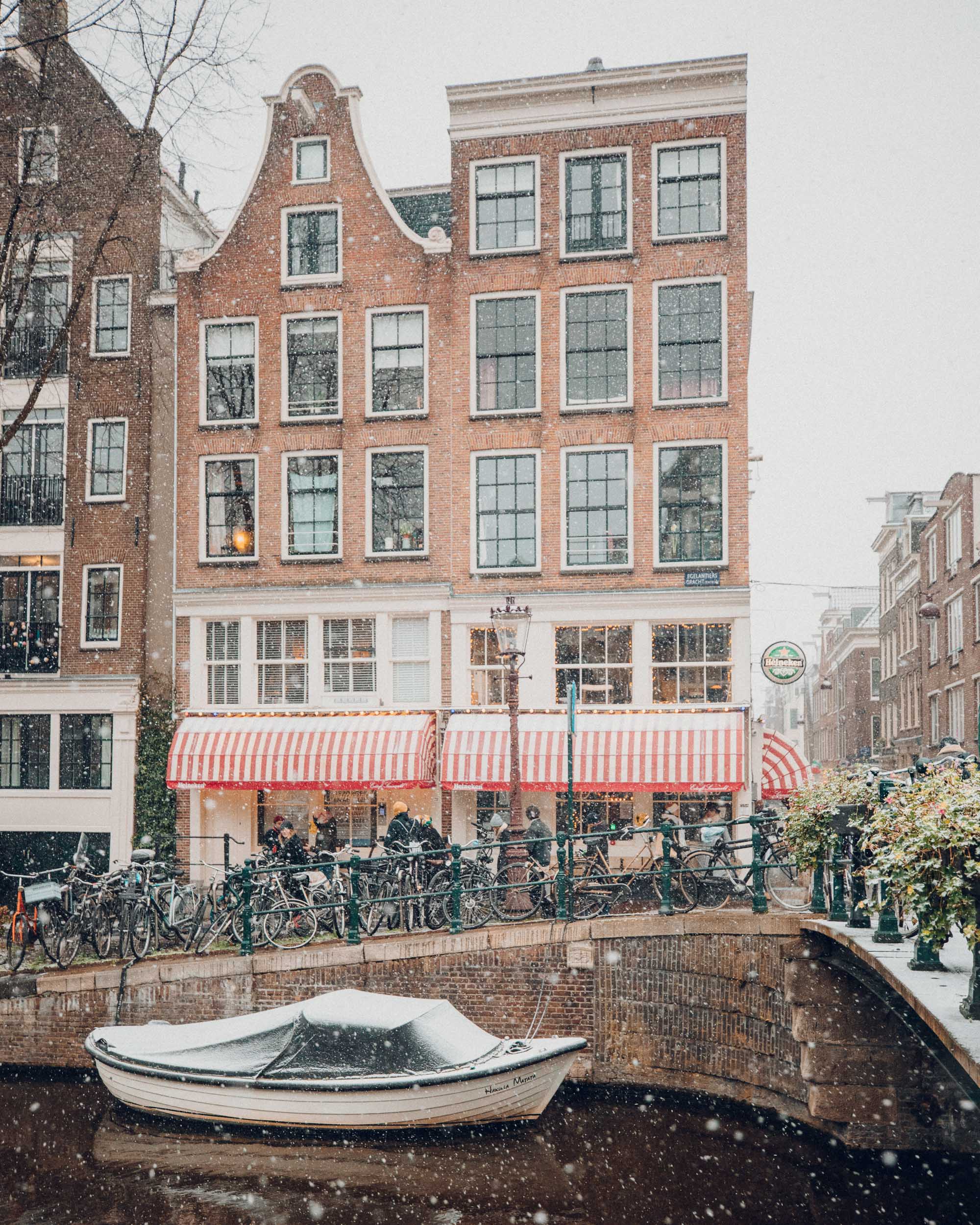 Amsterdam canal houses in the snow Find Us Lost